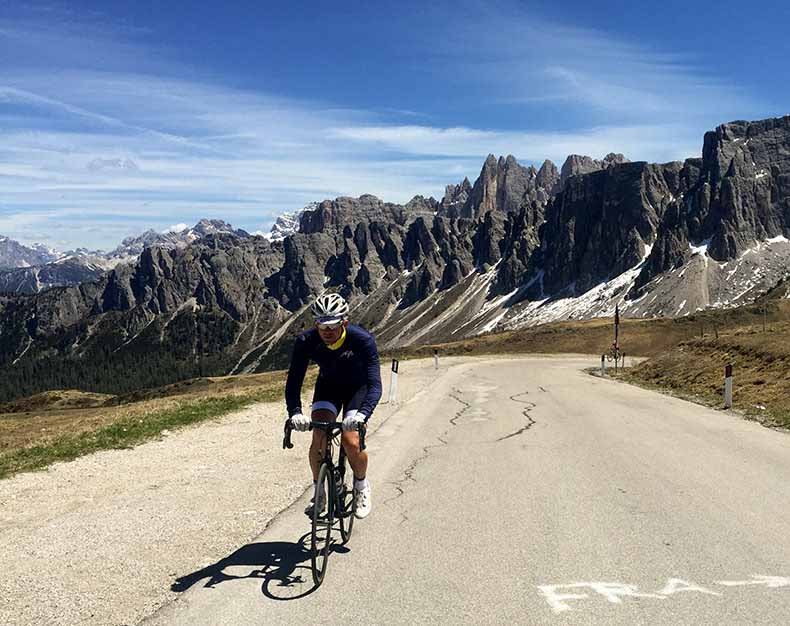 A rider cycling to the top of passo Giau