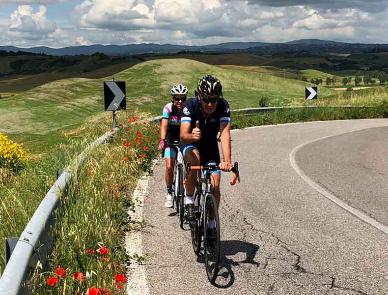 Two cyclists riding through the Crete Sinese in Summer