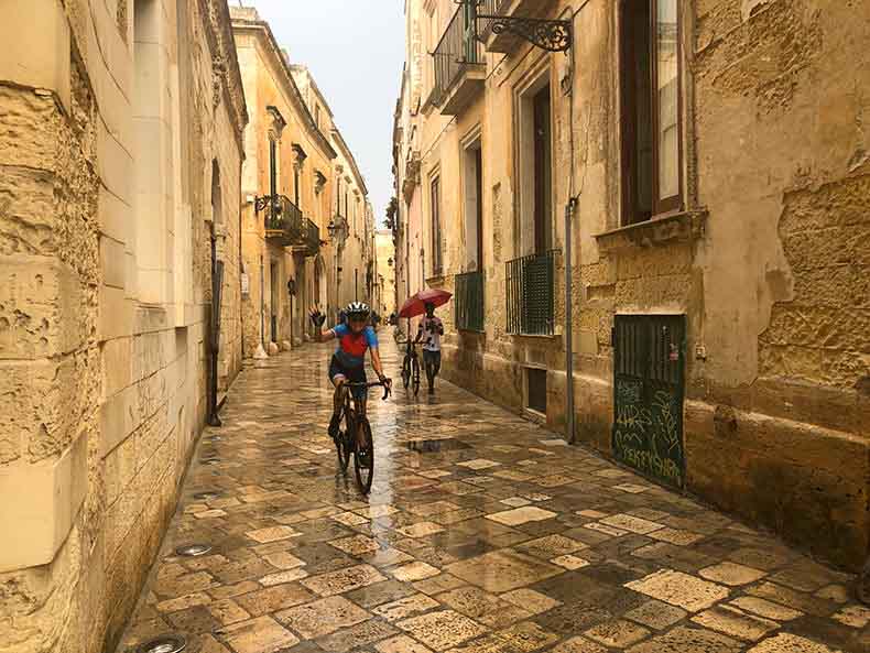 A cyclist riding on the olde cobbles of Lecce
