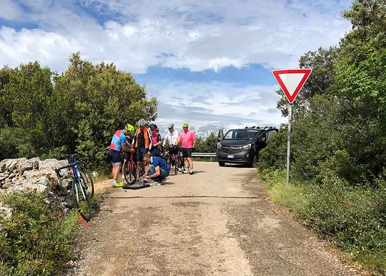 repairing a flat tyre in Puglia during a cycling holiday