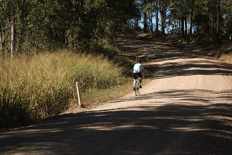 A cyclist riding up a hill