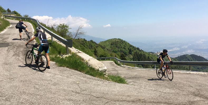 Cyclist riding up the steep climb of Monte Grappa