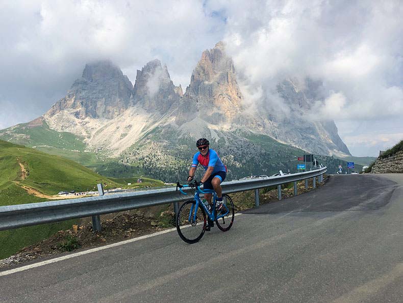 A cyclist riding to the top of Passo Sella