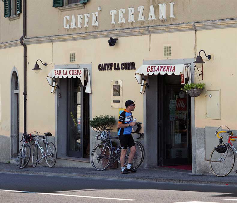 a cyclist outside a gelateria in Tuscany