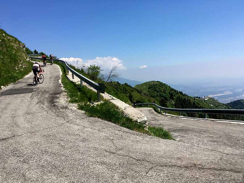 Cyclist riding up the steep slopes of Monte Grappa