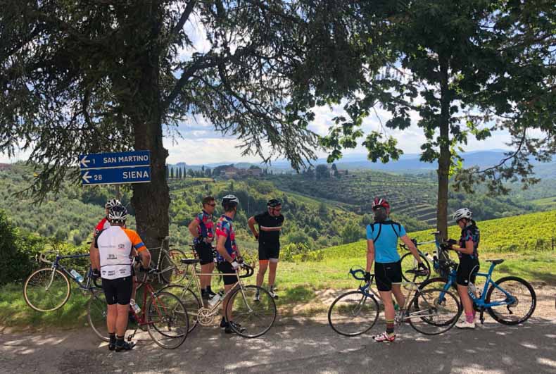 Cyclist stopped at a sign in Chianti Tuscany