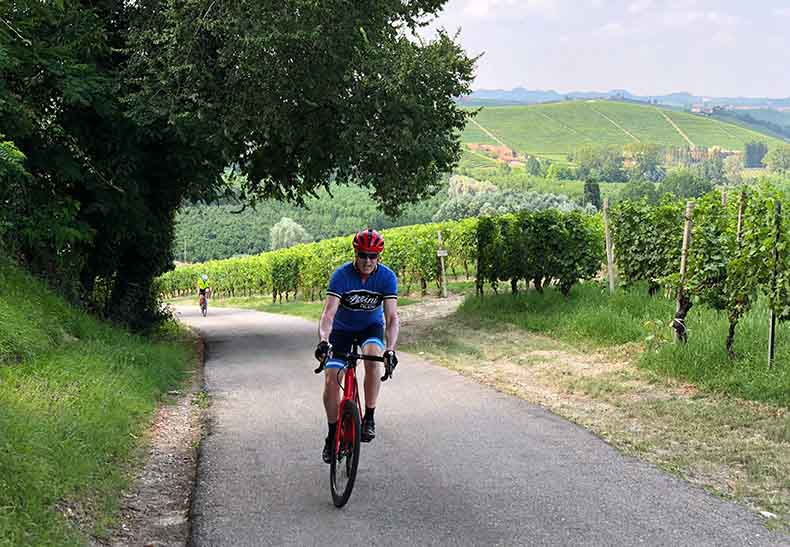 A man cycling up a hill in Piedmont