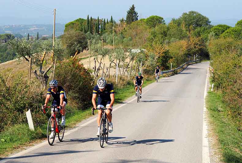 A group of riders cycling in Tuscany