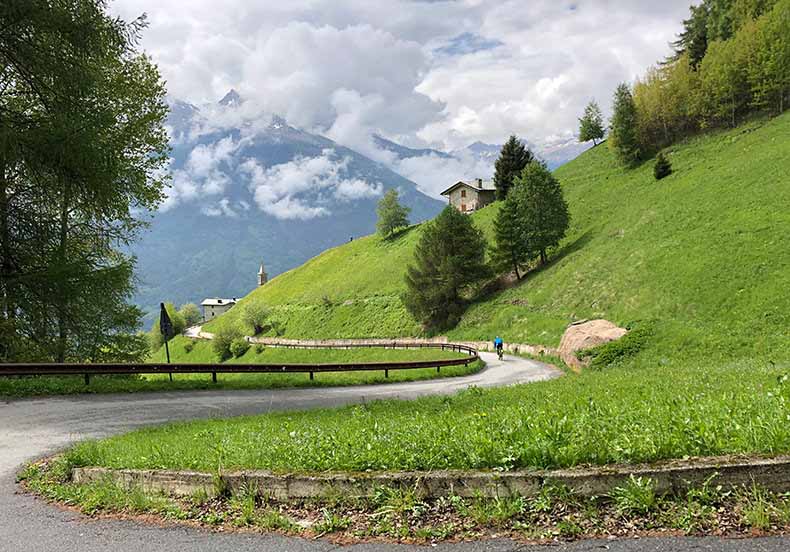 The road descending past a church from Mortirolo