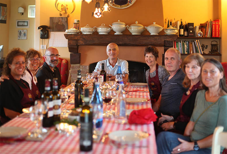 A group of people sitting around one table in Tuscany for dinner