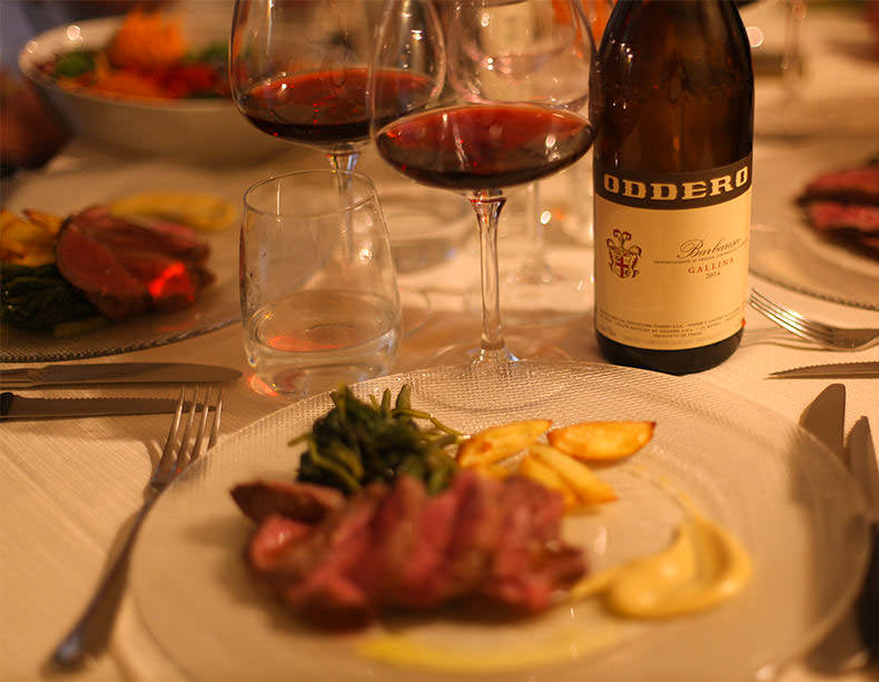two glasses and a bottle of Barbaresco and dinner in piedmont