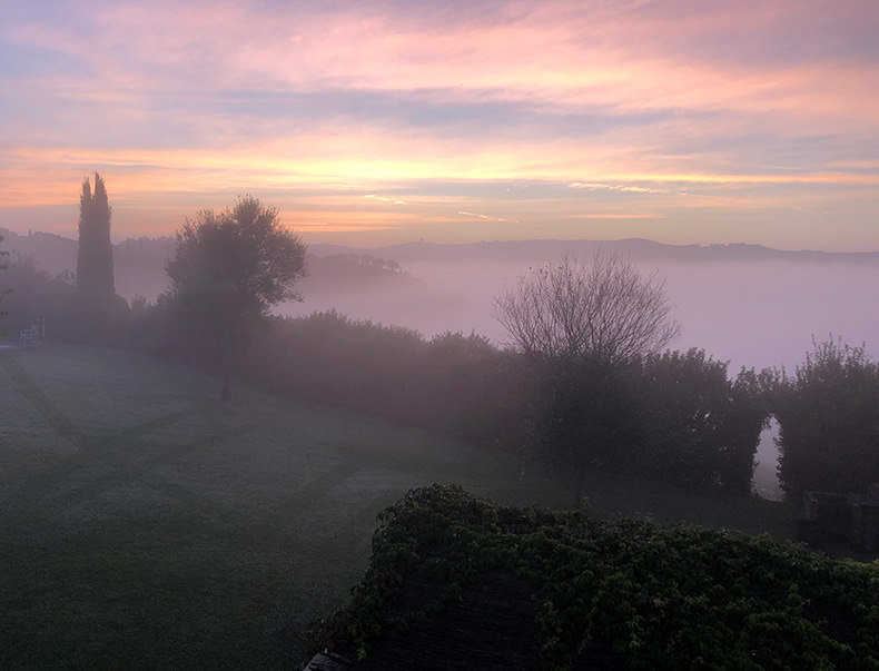 A sun rise in tuscany with low lying fog