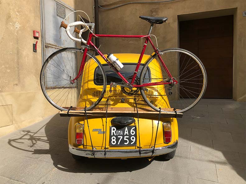 a Fiat 500 with a vintage steel bike on the back