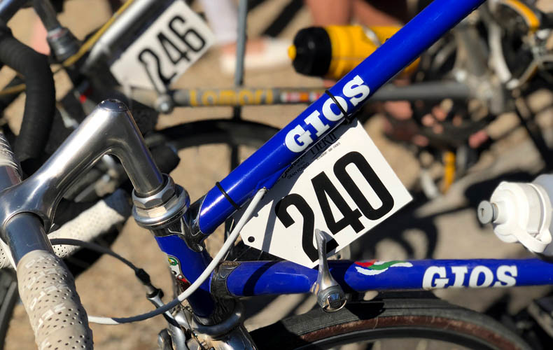 A blue Gios bicycle with a race number