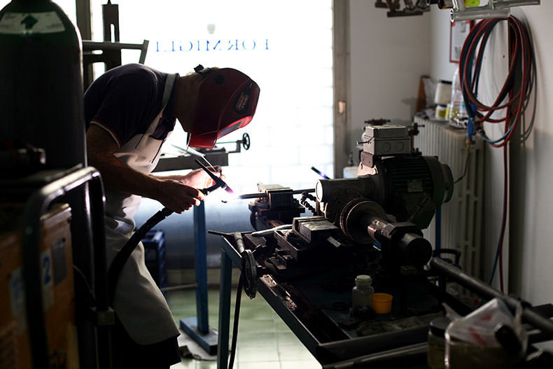 a man building a steel bicycle in Italy