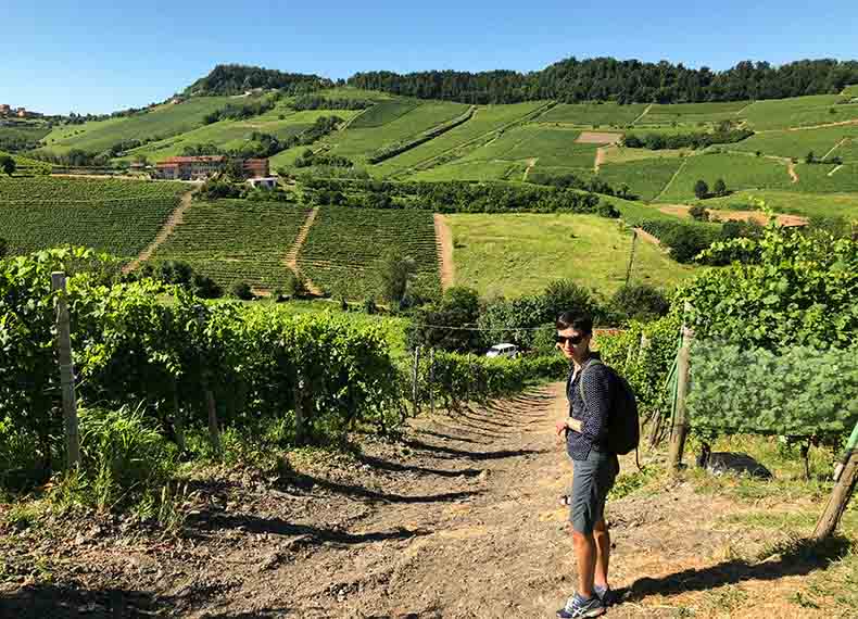 a woman hiking through the vineyards of Piemonte