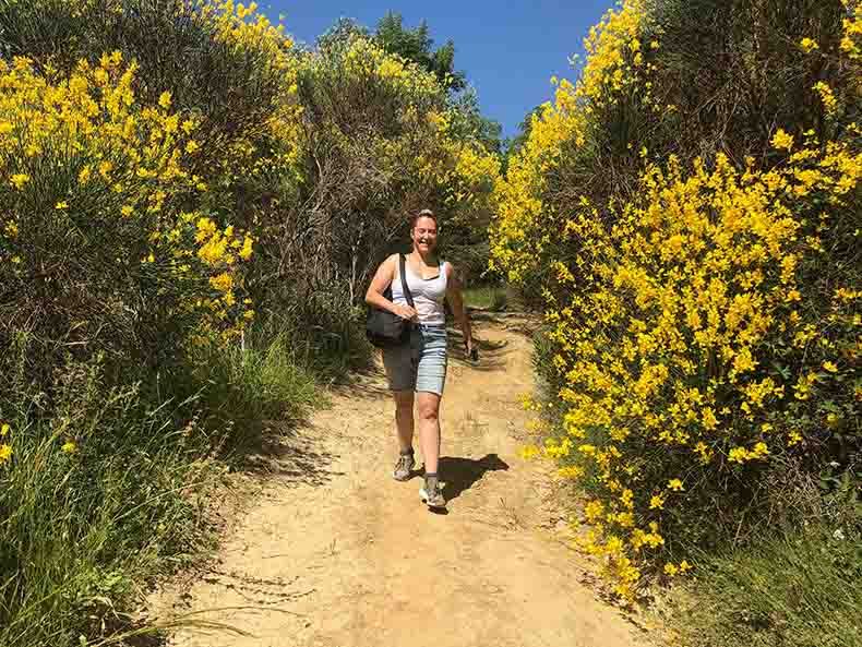 A woman hiking in the countryside in Tuscany