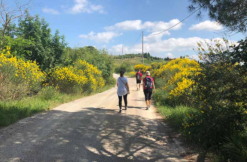 three people hiking in Tuscany