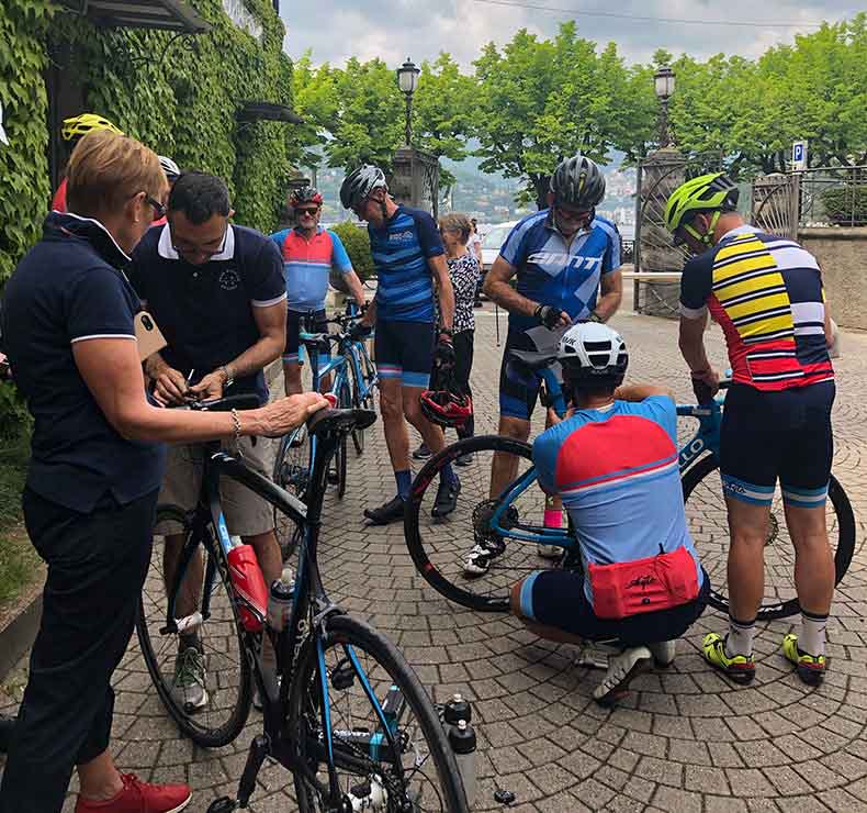 A group of cyclists adjusting their bicycles