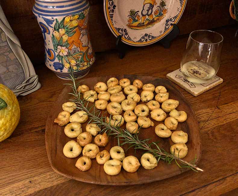 A glass of white wine and home made taralli