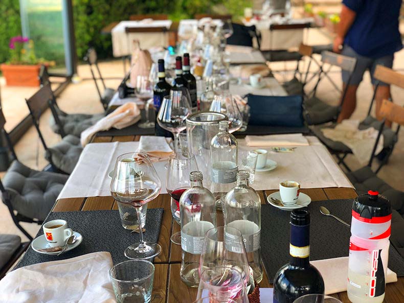 A lunch table full of empty glasses