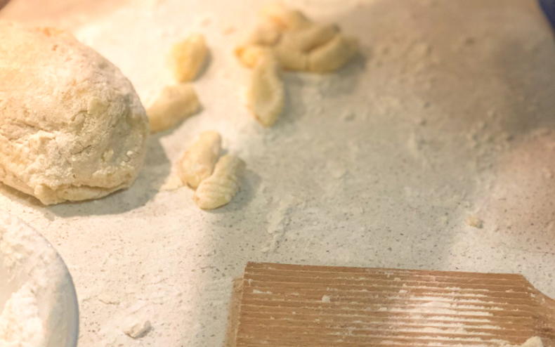 gnocchi, dough amd a wooden rolling board