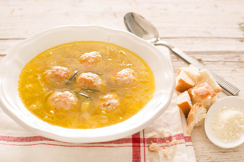 a bowl of meatballs in broth