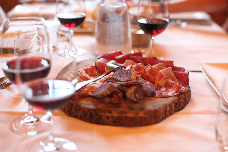 A board of salumi and four glasses of wine