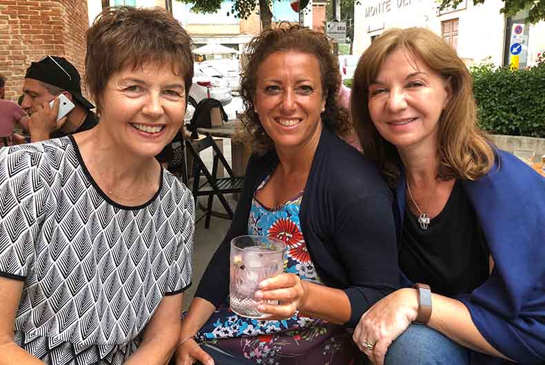 Three women drinking aperitivo in Tuscany