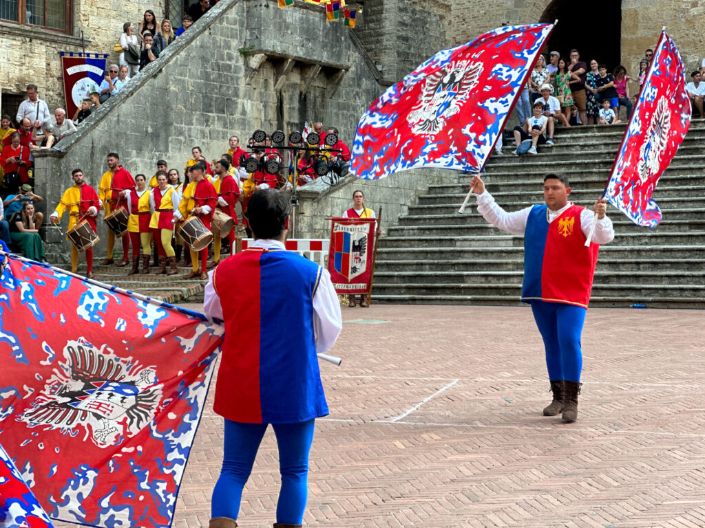 A historical festival in San Gimignano Tuscany with a flag throwing display