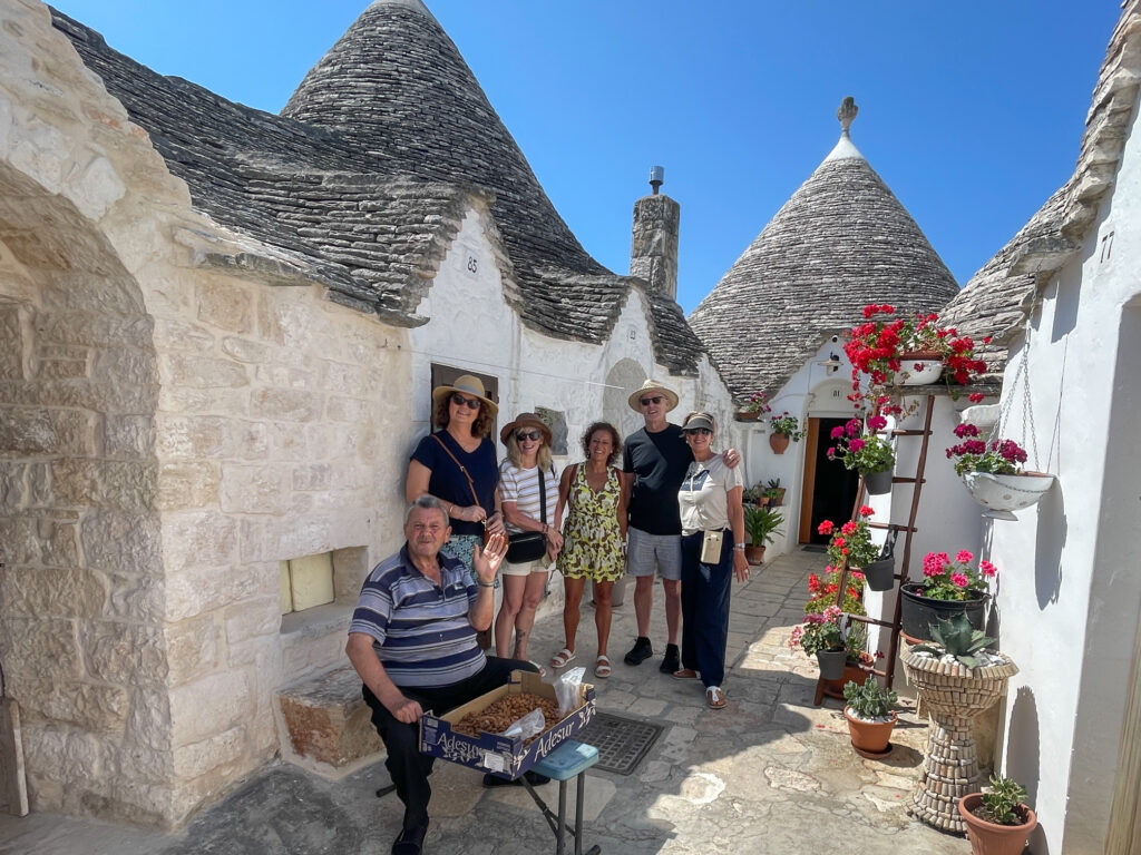 A group of people exploring Alberobello in Puglia