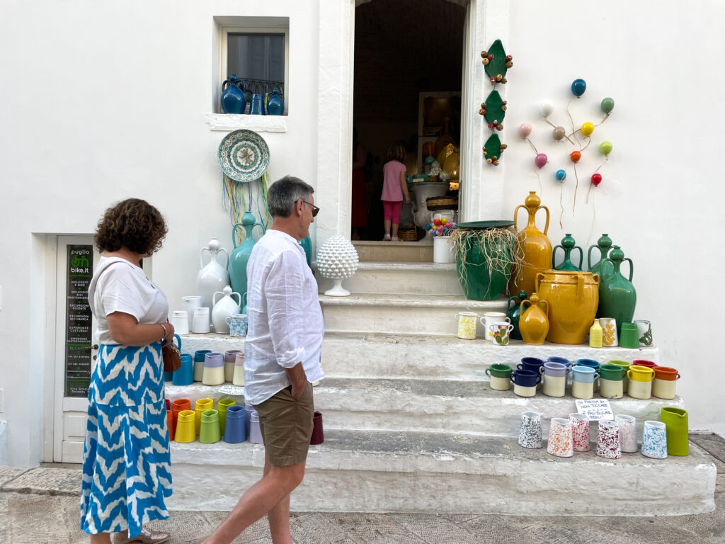 Two people looking at hand made ceramics in Locorotondo, Puglia