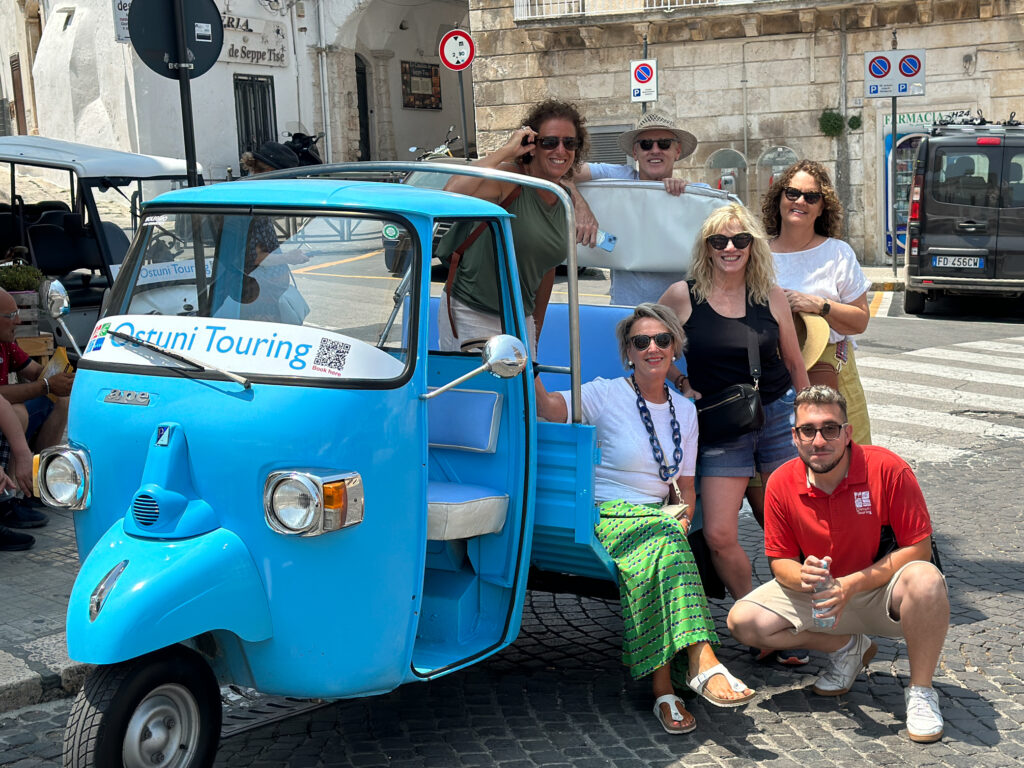 A group of people on a city tour of Ostuni in the Puglia region of Italy