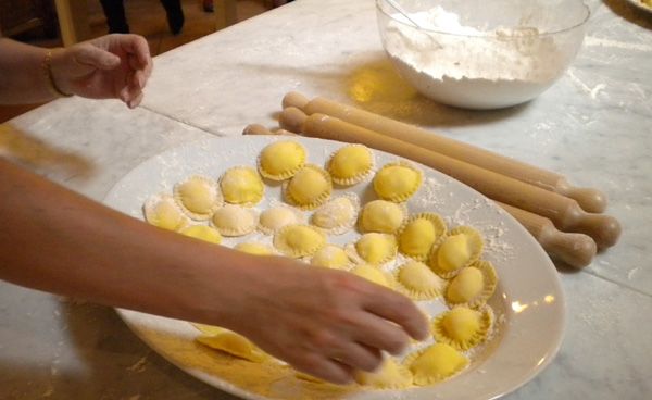 Someone making pasta by hand at a cooking class in Italy