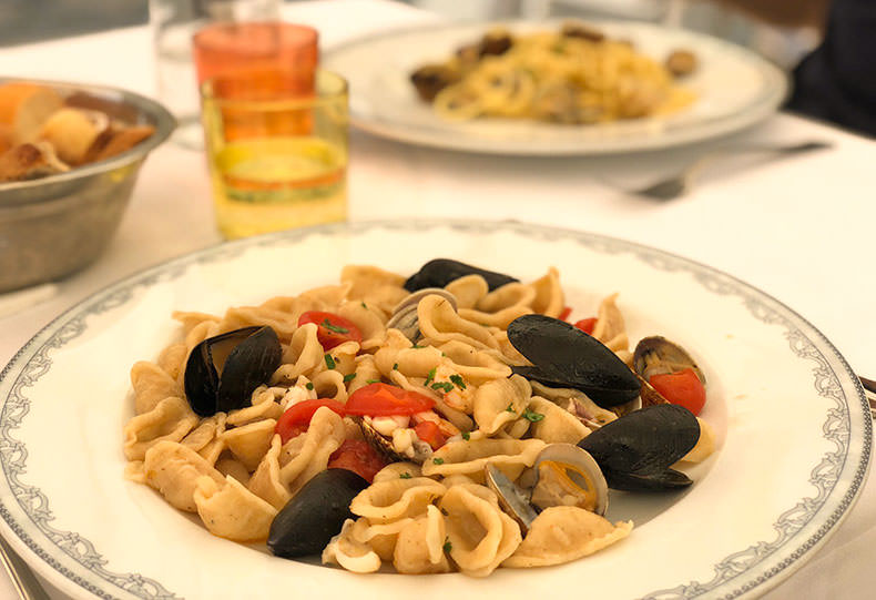 a plate of orecchiette with seafood
