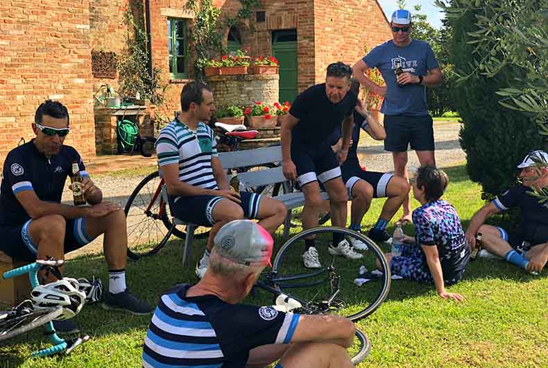 A group of riders having a beer in the shade after a ride on an Italian cycling Holiday
