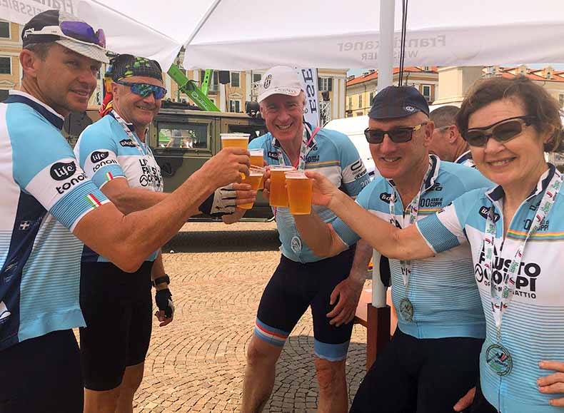 a group of cyclists having a celebratory beer after the La Fausto Coppi Gran Fondo