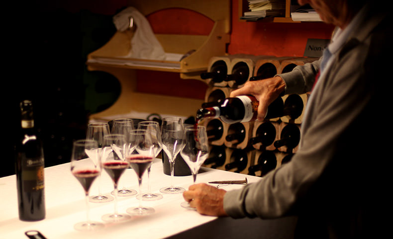A man pouring a glass of wine during a wine tasting in Tuscany