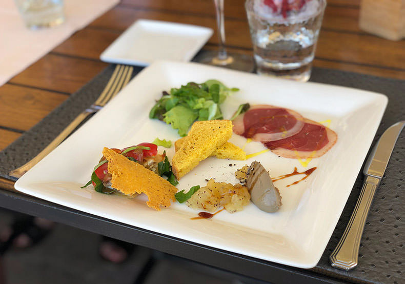 A plate of mixed antipasti at a restaurant in Tuscany