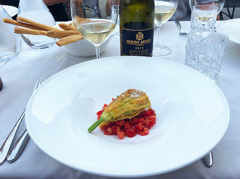 A glass of Arneis and stuffed zucchini flowers