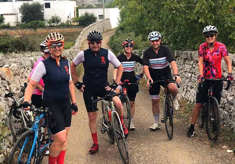 a group of cyclist on a small quiet road in Puglia