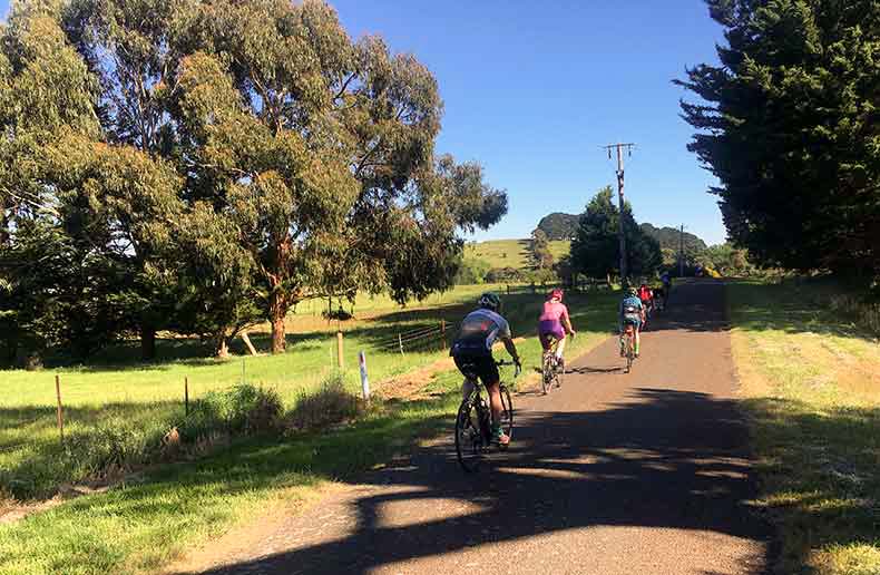 riders cycling on a quiet road in daylesford