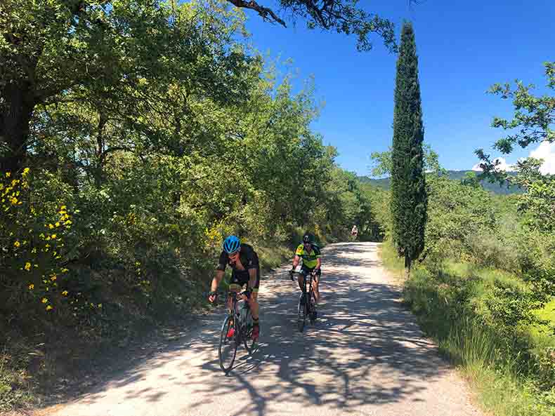 Two cyclist riding on the gravel in Tuscany