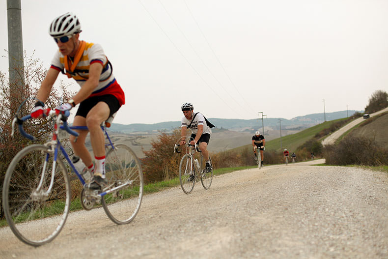 Cyclists riding on the gravel during L'Eroica