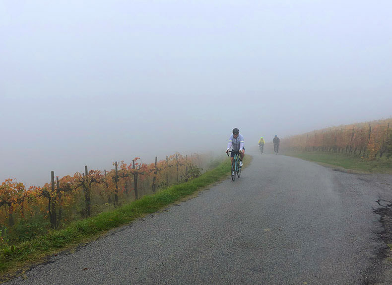 A man cycling through the fog in Piemonte