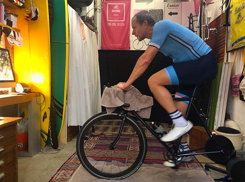 a cyclist riding a bike on an indoor trainer