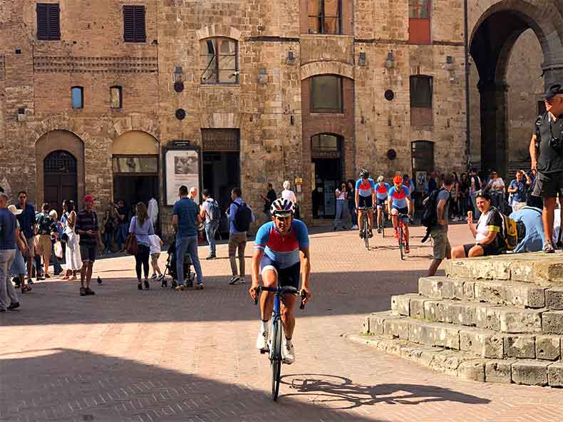 a man riding a bike in San Gimignano