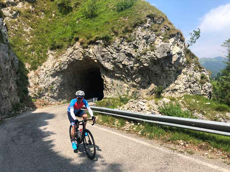 A cyclist coming out of a tunnel as he rides to the top of Monte Grappa