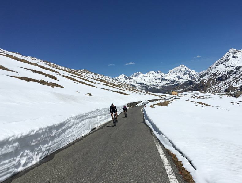 Cyclist riding up to Passo Gavia in the snow