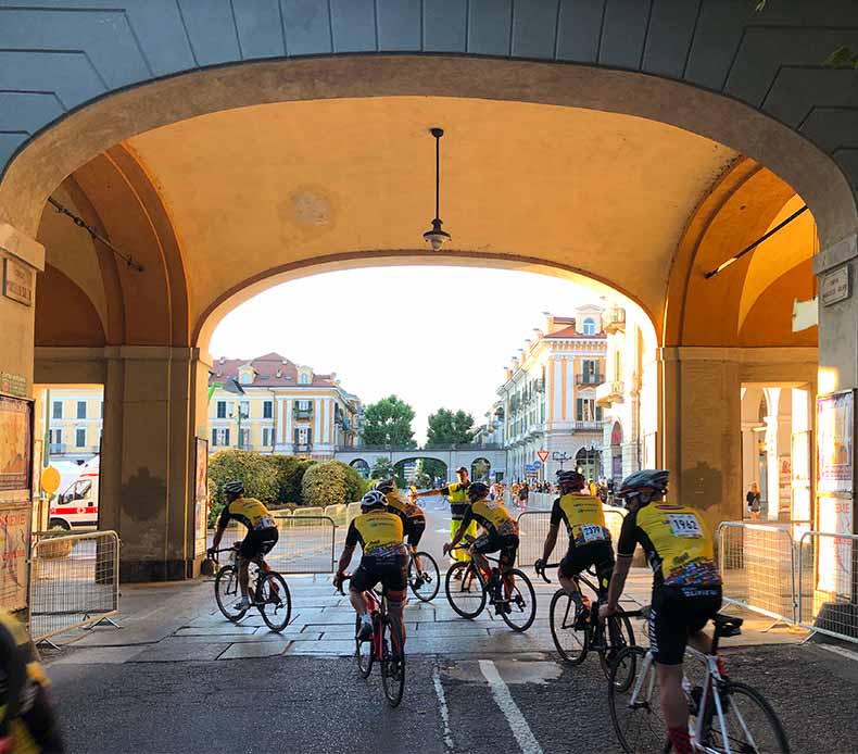 A group of riders cycling to the start of La Fausto Coppi Granfondo